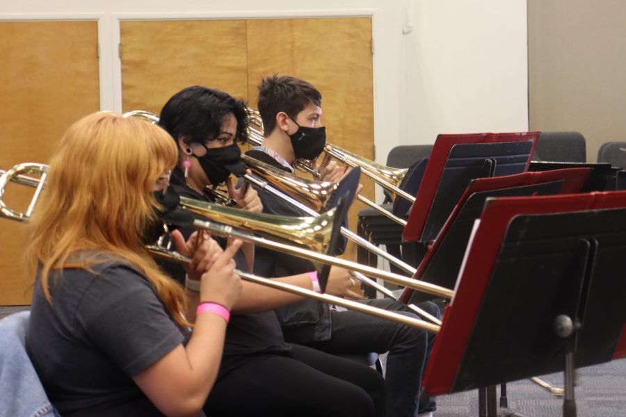 From left, Andrea Adame, Roxy Hernandez and Koby Pfonner, practice a new song wearing special masks with flaps to prevent the spread of COVID-19 on Thursday, Aug. 26, 2021, in Room 105 in the Drama/Music building at City College in Santa Barbara, Calif. Adame said playing through a mask was doable but a little bothersome on fast charts.