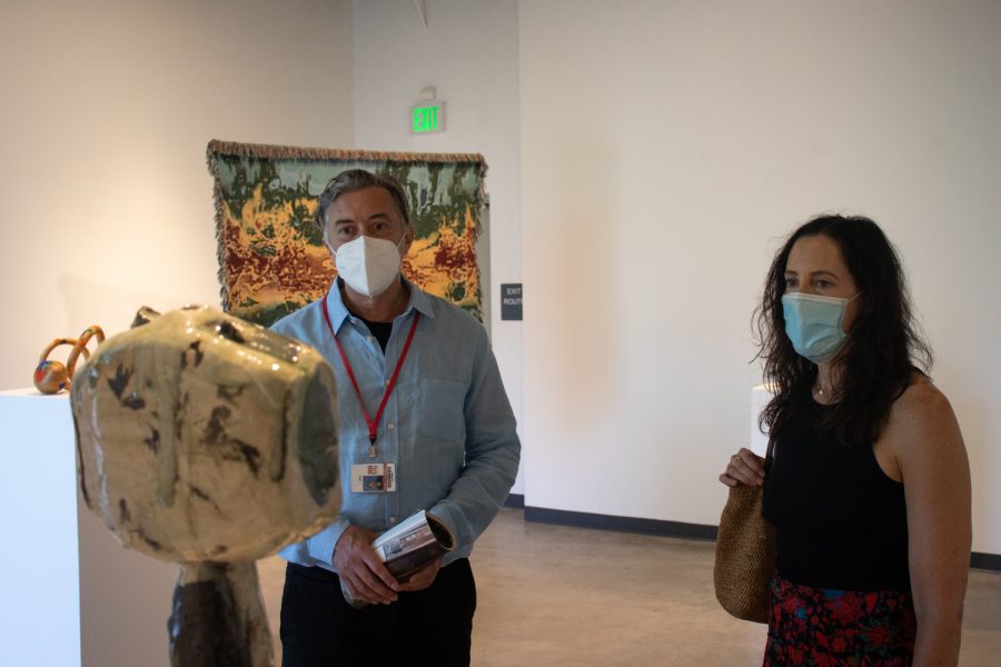 John Connelly shows his associate Kim Brown around City College's new exhibit, "Planet Earth," on Sept. 10 in the Atkinson Gallery at City College in Santa Barbara, Calif. The recurring theme of the exhibit is the space we occupy on the land and sea.