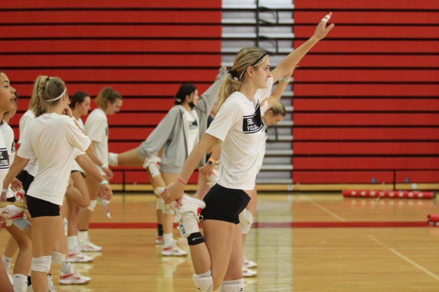 The women’s volleyball team warms up before practice on Sept. 21 in the Sports Pavilion at City College in Santa Barbara, Calif. Karoline Ruiz and her teammates are stretching out their hamstrings after doing a multitude of other stretches to avoid injury.