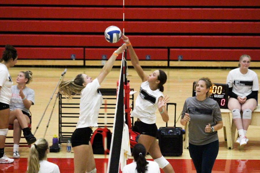Women’s volleyball player Lola Bunn (right) pushes the ball over the net while teammate Megan Harrington (left) tries to block her on Sept. 21 in the Sports Pavilion at City College in Santa Barbara, Calif. Assistant coach Bridget Kulesh watches eagerly to see what happens next.