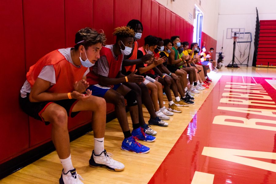 The 2021-2022 men's basketball team hold wall squats after running sprints during practice on Sept. 14 at City College in Santa Barbara, Calif. There are only two returning sophomores on the team this season.