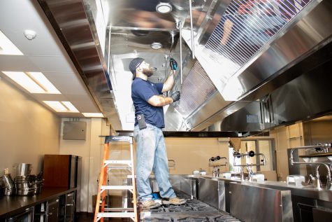 Local contractor Skyler Whitsett inserts and screws in a pipe that will attach to a water spout above the burners in the newly renovated kitchens on Oct. 13 at City College in Santa Barbara, Calif. The culinary department's kitchens were gutted and redesigned during the pandemic so as to not bother classes.