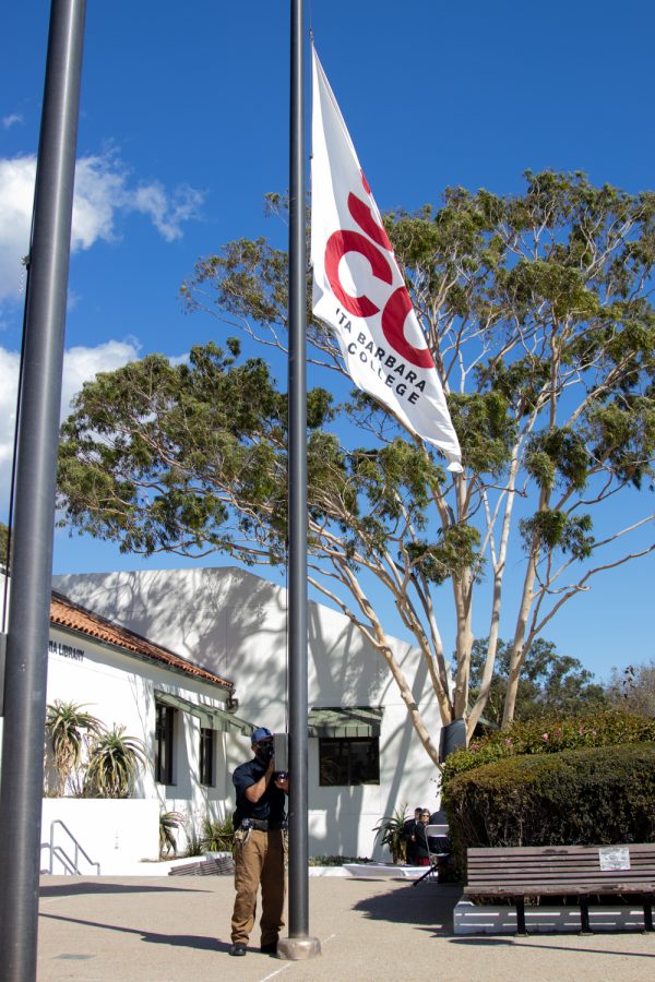 Campus Safety and Emergency Response Director Erik Fricke lowers City College's flag to half-staff in remembrance of deceased DSPS faculty member Janet Hose during a ceremony to honor her life and services to City College on Monday, Oct. 18 outside of The Luria Library in Santa Barbara, Calif. The flag is put half-staff to metaphorically make room for the invisible flag of death. 