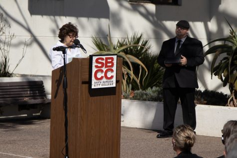DSPS Counselor Michele Bass recalls the unique style of deceased DSPS faculty member Janet Hose alongside IT User Support Services Director and Campus Chaplain Jason Walker during a flag lowering ceremony to honor Hose’s life and services to City College on Monday, Oct. 18 outside of The Luria Library in Santa Barbara, Calif. Bass said that she will always remember Hose while putting on her shoes every morning because they had a similar pair, which was odd because Hose’s taste was “one-of-a-kind” according to Bass.