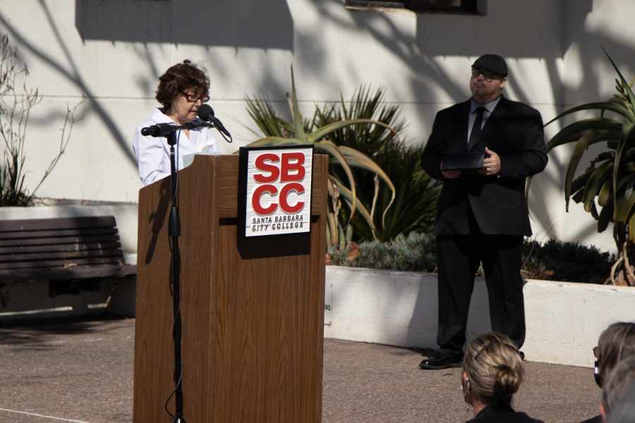 DSPS Counselor Michele Bass recalls the unique style of deceased DSPS faculty member Janet Hose alongside IT User Support Services Director and Campus Chaplain Jason Walker during a flag lowering ceremony to honor Hose’s life and services to City College on Monday, Oct. 18 outside of The Luria Library in Santa Barbara, Calif. Bass said that she will always remember Hose while putting on her shoes every morning because they had a similar pair, which was odd because her taste was “one-of-a-kind” according to Bass. 