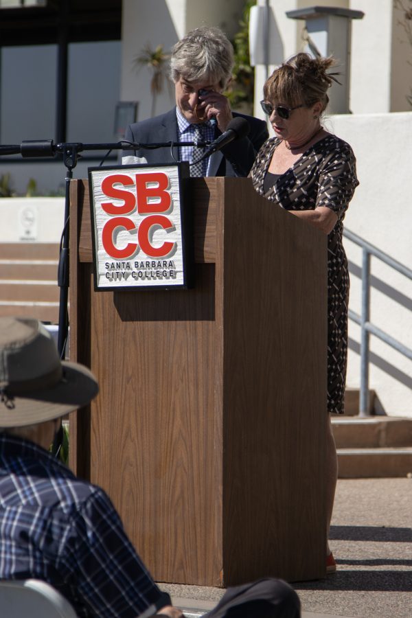 Ron Taylor wipes a tear from his eye as his wife, retired Learning Disability Specialist Lesley Taylor, recalls the times she shared with deceased DSPS faculty member Janet Hose during a flag lowering ceremony to honor Hose’s life and services to City College on Monday, Oct. 18 outside of The Luria Library in Santa Barbara, Calif. Many speakers teared up while remembering their time spent with Hose. 