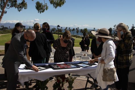 Retired Learning Disability Specialist Lesley Taylor, center, surrounded by friends and colleagues of deceased DSPS faculty member Janet Hose, examines a table laden with pictures honoring Hose during a flag lowering ceremony to honor her life and services to City College on Monday, Oct. 18 outside of The Luria Library in Santa Barbara, Calif. Hose's family, who live on the east coast, told City IT User Support Services Director and College Chaplain Jason Walker they were sad they could not attend.