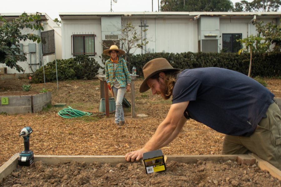 Student Jezebel Kenny asks instructor Lewis Daniel if the “tomatoes” sign that he is drilling into the planting bed is level on Sept. 24 at City College’s food garden in Santa Barbara, Calif. Each bed is designated to a specific vegetable that City College’s permaculture students will tend to and eventually harvest for the culinary department to cook in the cafeteria.