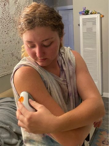 Jenna McMahon applies her Dexcom, which checks blood sugar levels every five minutes on Sept. 20 at La Brezza apartments in Santa Barbara, Calif. The Dexcom sends alerts to her phone to notify if her blood sugar is too high or too low.