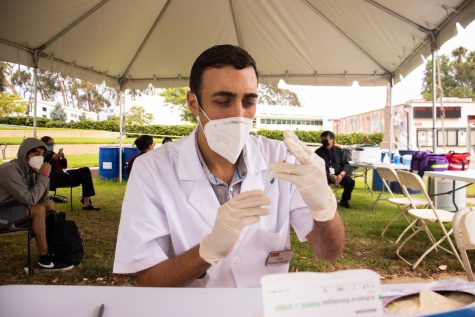 Vons Pharmacy Manager Chris Gregory loads a syringe with a shot of the Johnson and Johhnson COVID-19 vaccination on Sept. 16 at City College in Santa Barbara, Calif. After students got their shot they were told to wait for 15 minutes to make sure they don't have a negative physical reaction.