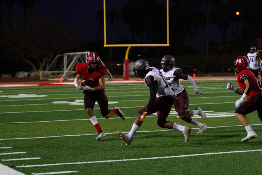 No. 7 Chase Wells runs the ball down the field during the game against Antelope Valley on Oct. 30 at La Playa Stadium in Santa Barbara, Calif. Wells received for a total of 93 yards throughout the game. (<a href="https://www.thechannels.org/staff_profile/kapono-lizama/">Kapono Lizama</a>)