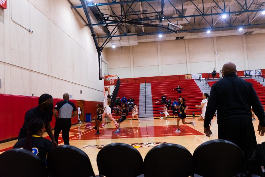 The LA Harbor sideline watches as the Vaquero’s drive towards the basket on Nov. 10 at the Sports Pavilion at City College in Santa Barbara, Calif. City College defeated LA Harbor 66-64.