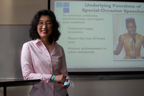 Public speaking Professor Mika Garard poses at her podium in her classroom on Tuesday, Nov. 30 at City College in Santa Barbara, Calif. Originally from Japan, Garard said she loves teaching in Santa Barbara and is thankful to be back to in-person classes.