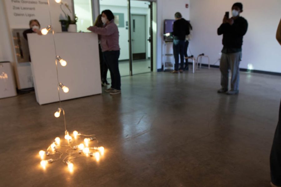 Atkinson Gallery visitors admire Felix Gonzalez-Torres piece Untitled(Silver) during the show What is America? on Thursday, Feb. 24 at City College in Santa Barbara, Calif. Gallery Director John Connelly plans to drape the piece over various places around City College while the show What is America? shows at City College.