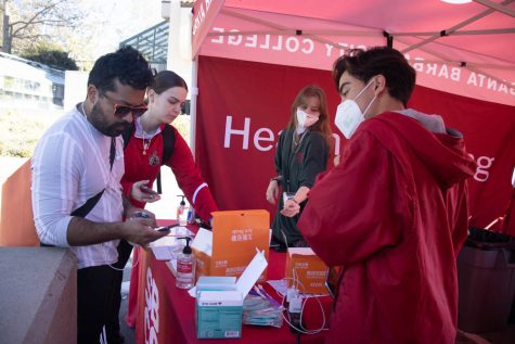 From left, two City College students check in with student workers Jolie Slack and Jonathan Dinh at City College's west campus healthy screening station on Monday, Feb. 7 in Santa Barbara, Calif. In order for to enter a building on City College's campus, individuals need to upload their vaccination status or proof of exemption, submit a negative COVID-19 test once a week and wear an N95 or KN95 mask.