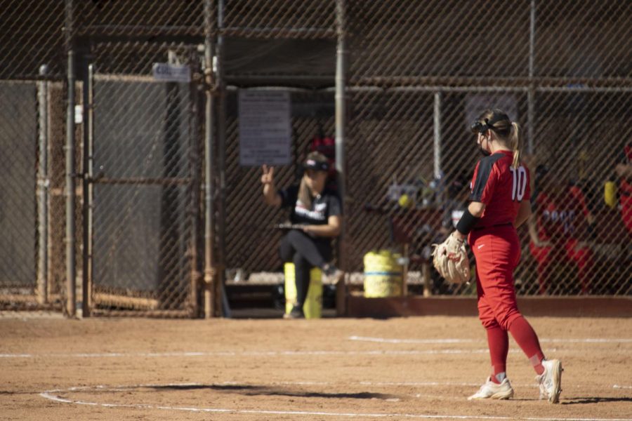 Lauren Indermuehle reads signals from head coach Yasmyne Perry during City College's game against San Bernardino College on Feb. 5 at City College's baseball diamond in Santa Barbara, Calif. The San Bernardino Wolverines eliminated the City College Vaqueros two games to zero.