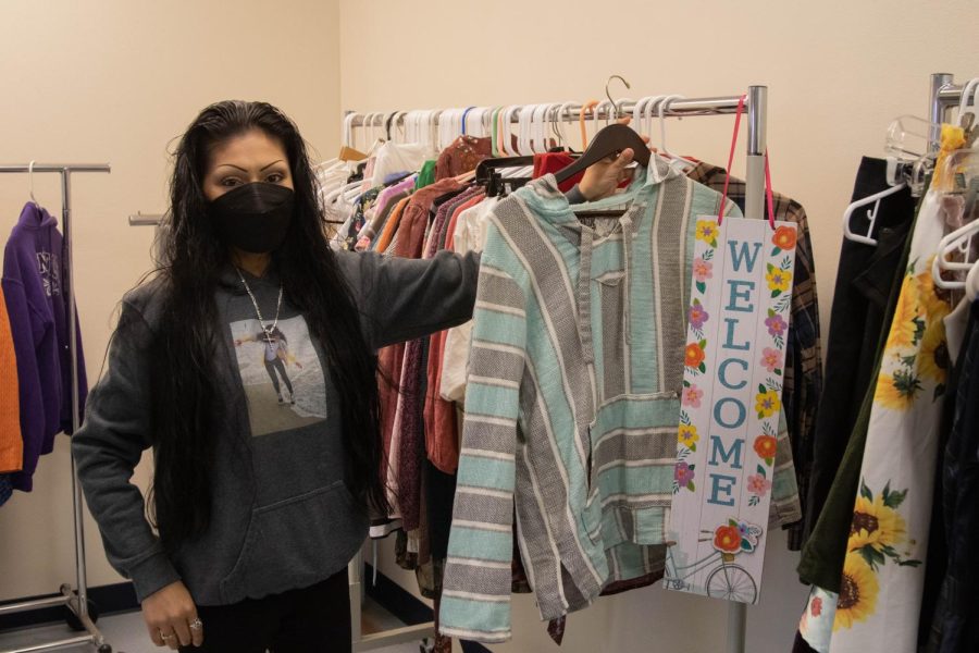 Substitute Equity Student Program Advisor Alondra Lazaro Gonzalez displays items available at Loves Closet in the Basic Needs Center on Thursday, Feb. 24 at City College in Santa Barbara, Calif. Students can schedule a 15-minute appointment where they have the store to themselves and are able to choose up to three items of gently loved clothing to take home for free.