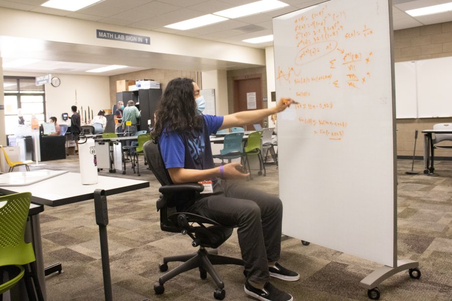 Math tutor Christopher Therrien explains how to solve a math problem on April 11 at City Colleges Math Lab in Santa Barbara, Calif. The math lab is open to all students looking for help with most maths. 