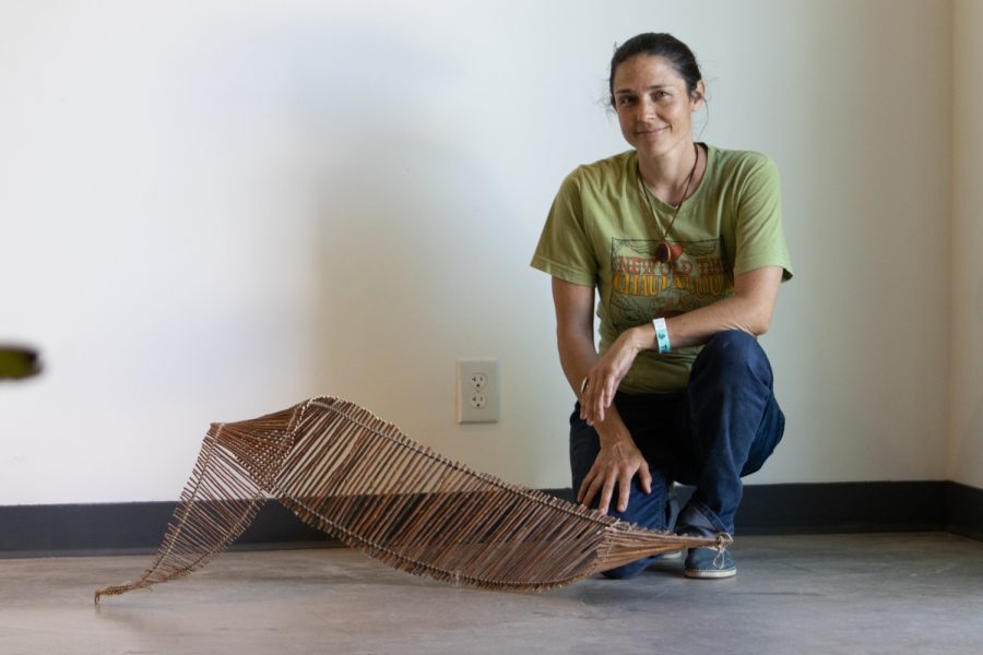 City College art student Kathryn Lape poses with her piece, "Ladder," on April 5 at the "Structure and Skin II" Atkinson Gallery pop-up exhibition at City College in Santa Barbara, Calif. This piece is made of red willow wood, string and wire.
