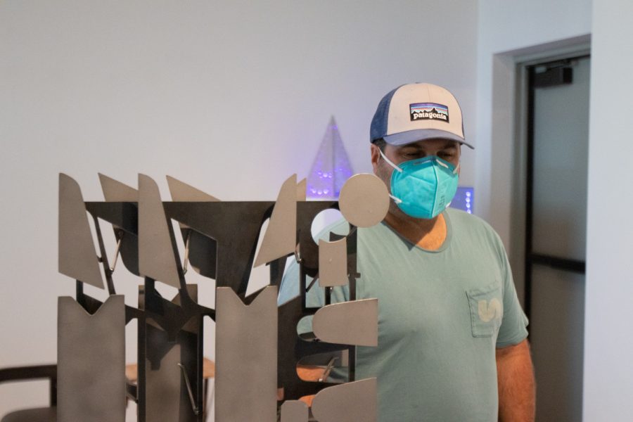 An Atkinson Gallery visitor catches a glimpse of the sculpture "Phractured" as he winds his way through different sculptures on April 5 at the "Structure and Skin II" Atkinson Gallery pop-up exhibition at City College in Santa Barbara, Calif. Santa Barbara community members were encouraged to visit and interact with each of the works and artists.