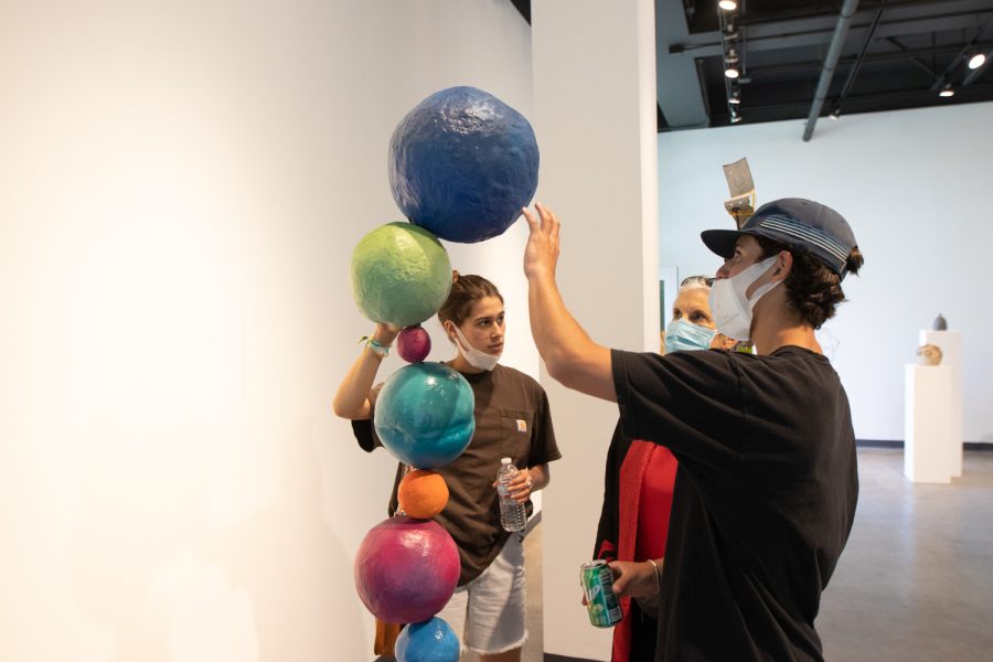 City College students critique the piece by student Ruth Bar-Shalom, "Planetary Totem," on April 5 at the "Structure and Skin II" Atkinson Gallery pop-up exhibition at City College in Santa Barbara, Calif. This piece is made of clay, paper, glazes, acrylic and steel.