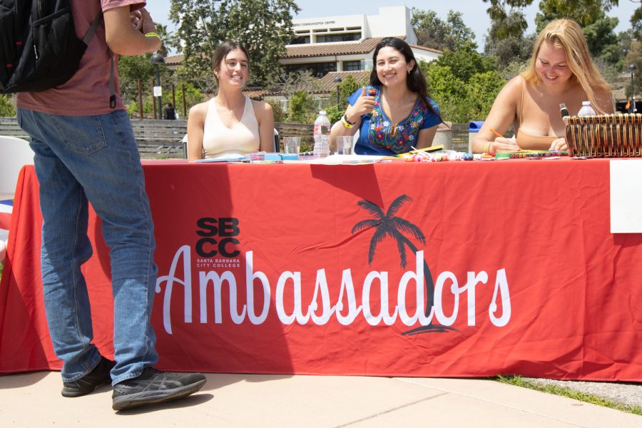 From left, student ambassadors Lexa Welch, Jackie Estrada and Moa Cronheden welcome students to the "Unity In The CommUNITY" festival on April 27 in Santa Barbara, Calif. 