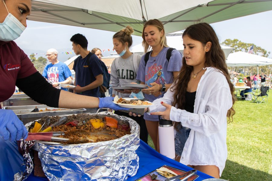 City College student Minami Cramer gets a plate of food at the "Unity In The CommUNITY" festival on April 27 in Santa Barbara, Calif. Free food and drinks were given out during the festivities.