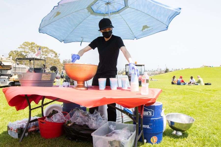 Animation major Pedro Torres preps drinks for the "Unity In The CommUNITY" festival on April 27 in Santa Barbara, Calif. Free food and drinks were given out during the festivities. 