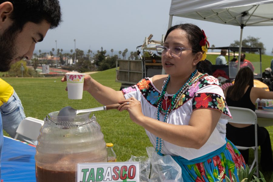 Nursing major Diana Roman, representing Mexico, serves horchata to a City College student during the "Unity In The CommUNITY" festival on April 27 in Santa Barbara, Calif. 