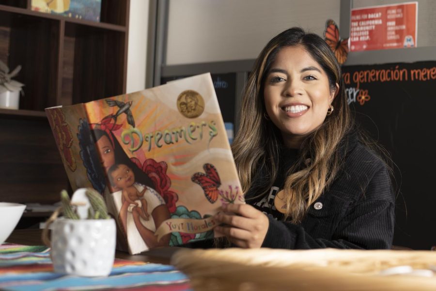 Dream Center Student Program Advisor Leslie Marin reads “Dreamers” by Yuyi Morales in her office in the Center for Equity and Social Justice (CC-228) on Oct. 13 at City College in Santa Barbara, Calif. As a first-generation dreamer, Marin brings experience to her new position as a full-time Student Program Advisor.