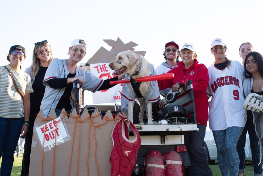 Members of the City College Athletics Department line up at their Sandlot themed tailgate on Oct. 27 at the West Campus Great Meadow in Santa Barbara, Calif. Their trunk display was supported by loyal mascot, Max the Dog, seen center frame wearing a red bat and baseball jersey.
