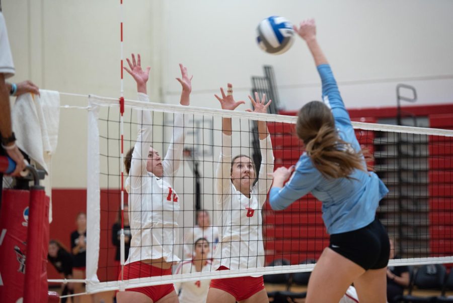 Grace Wells (No. 12) and Megan Harrington (No. 6) reach for a block at the net on Oct. 12 in the Sports Pavillion at City College in Santa Barbara, Calif. Shortly after, the team rallied together to clinch the third set, 27-25.
