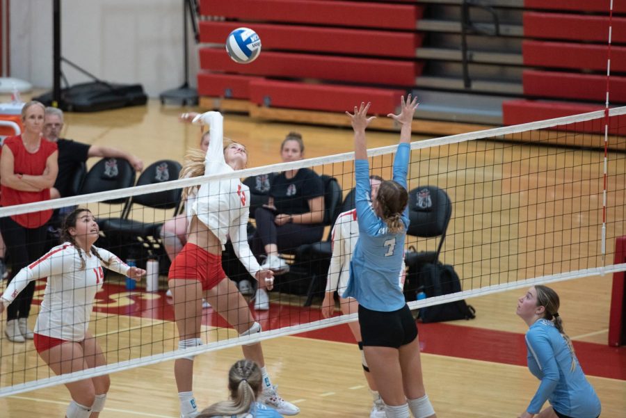 Middle blocker Karoline Ruiz (No. 13) spikes the ball towards blocking middle hitter Ryann Gaglio (No. 7) on Oct. 12 in the Sports Pavillion at City College in Santa Barbara, Calif. The Vaqueros played with high energy, but were ultimately defeated by the Moorpark Raiders, 1-3.