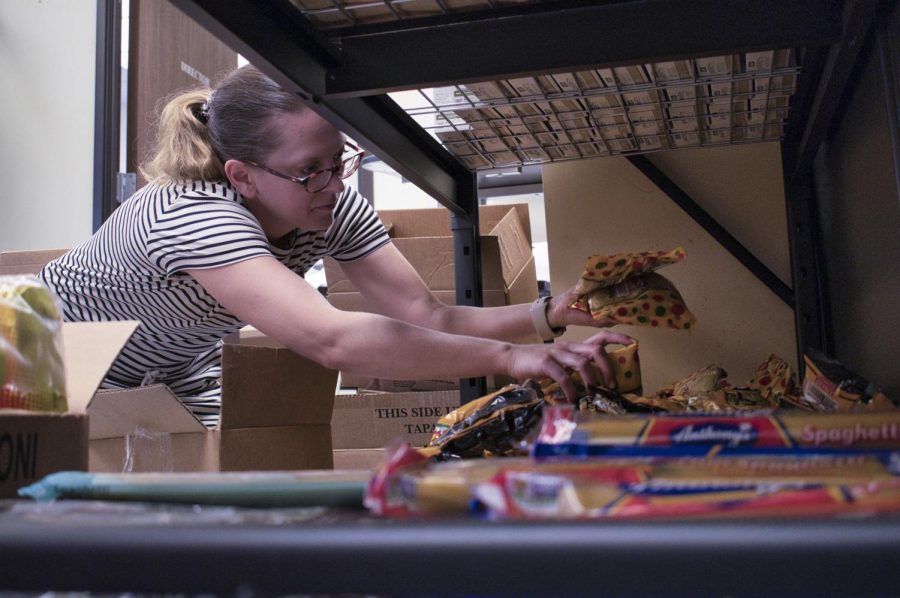 Interim Director of the School of Extended Learning Rachel Walsh stocks food pantry shelves with freshly delivered food on Oct. 7 at City College Wake Campus in Santa Barbara, Calif. Walsh volunteered on her own time to support the food pantry’s mission and stayed throughout the entire restocking process.