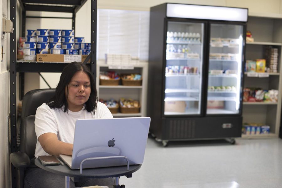 Office of Equity Assistant Aranzazú Magallanes works on her laptop at the food pantry check-in station on Oct. 5 at City College Wake Campus in Santa Barbara, Calif. All City College students are eligible to receive free food through the newly established pantry.