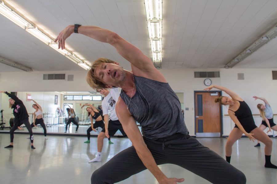 Dance instructor Tracy Kofford in grande plié second position during warm-ups with his beginning modern dance technique class on Oct. 27 at City College in Santa Barbara, Calif. This warm-up is important for the dancers because it gets their body flowing and muscles stretched.