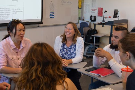 Teacher Betsy Cassriel sits in on a group of students playing a game with English flashcards on Oct. 17 at the Humanities building in Santa Barbara, Calif. Cassriel said she just wants every student to have a good experience in college.