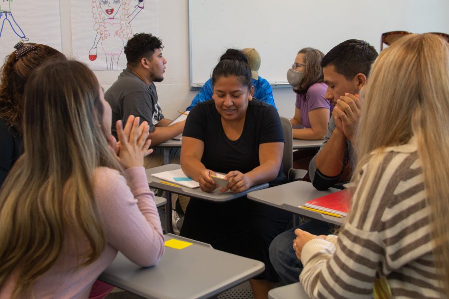 ESL student Cecilia Diaz works with her group answering questions in English on Oct. 17 at the Humanities building in Santa Barbara, Calif. The questions on the flashcards varied from asking students what their biggest fear is to describing appearances of a family member.
