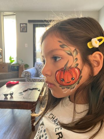 Emilia Acosta with a pumpkin face paint design on Oct. 31 in her home. “I love [to] take pictures of my daughter any chance I get especially if she has a design done by Mom,” Jose Acosta wrote.