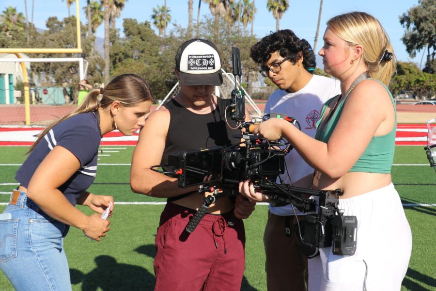 From left, Manhattan Wood, Luke Thatcher, Carlos Costillo and Riley Carter start prepping for the scene to begin on Oct. 29 at La Playa Stadium in Santa Barbara, Calif.