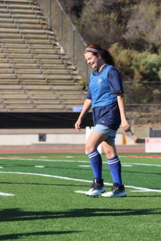 Actress Kirsten Hansen smiles and walks to her starting position to continue filming on Oct. 29 at La Playa Stadium in Santa Barbara, Calif.