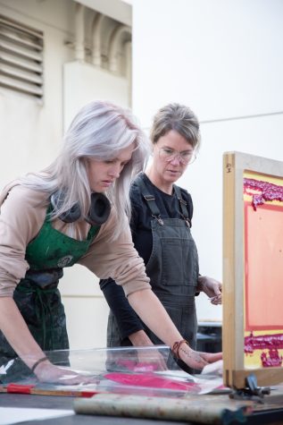 Gigi Macioce (left) receives guidance from Professor of Printmaking Stephanie Dotson as she works on the printing press on Nov. 17 at City College in Santa Barbara, Calif. The collaborative workspace encouraged by Dotson empowers students to pass along skills to others