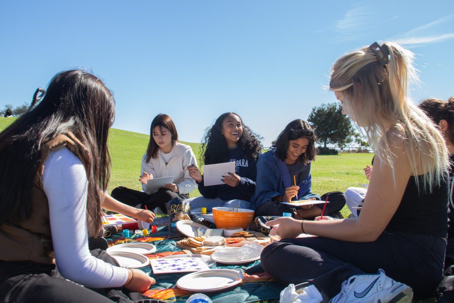 President of the Women For Success Club, Andrianina Rajaosera (center), laughs with her fellow club member, Divya Ramesh (right) on Nov. 3 on the Great Meadow at City College in Santa Barbara, Calif. Rajaosera started the Women For Success Club in April.