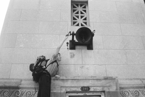 Matthew Reed ringing a big bell attached to the side of a building in August. This photo brings joy because “Everybody loves to ring bells,” Carly Gertsman wrote.