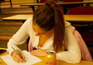 Deniz Ozdingis participates in the free writing portion of the Wellness in Words workshop before beginning her first poem of the night on Wednesday, Nov. 16 in Santa Barbara Calif.