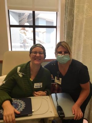 Amy Geriak (left) and one of her nurse practitioners celebrate Amy's last chemotherapy appointment on May 1, 2020 in San Fransisco, Calif.