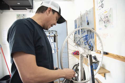 Bike mechanic Michael Velasquez adjusts the trueness of a wheel inside City College’s Campus Bike Shop on Nov. 30 in Santa Barbara, Calif. In addition to managing community bike shops, Velasquez serves as a technician to guide students through their repairs.