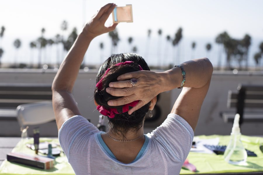 Deborah Cristobal looks up to her mirror while adjusting the alignment of her hair extension on Oct. 27 in Santa Barbara, Calif. The overall transformation process for her role took Cristobal two and a half hours of concentration to complete.