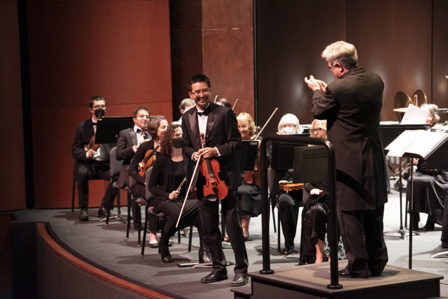 Concertmaster Kevin Kishiyama smiles toward conductor James Mooy after performing the feature solo in John William’s “Theme from Schindler’s List” on Dec. 4, 2022 at the Garvin Theatre in Santa Barbara, Calif. Kishiyama’s performance carried the mournful melody throughout the venue.