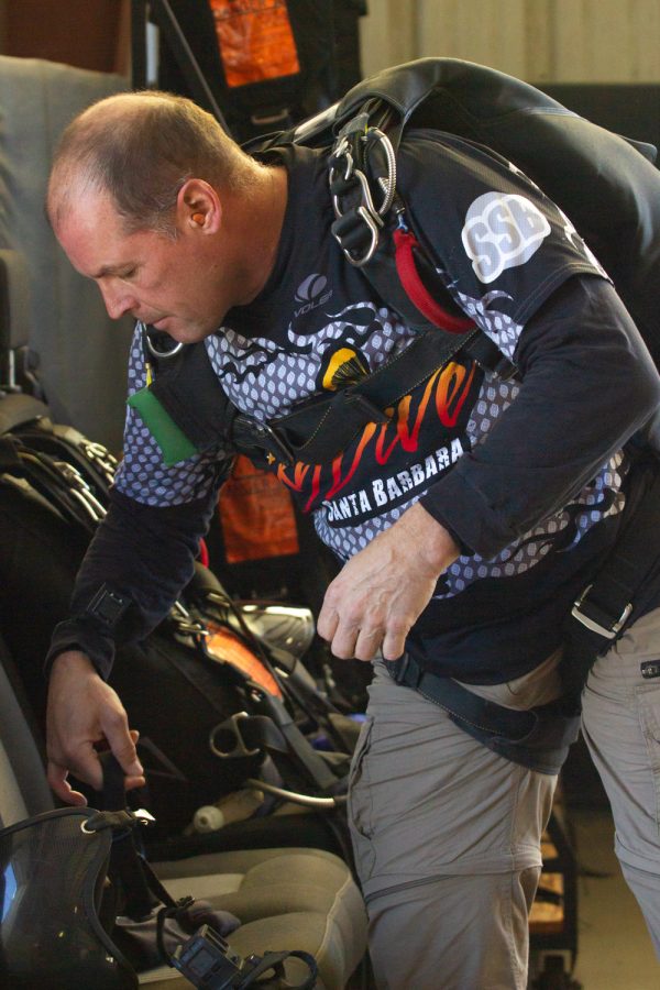 Tandem skydiving instructor Tom Pecharich grabs his helmet in preparation for the next jump on Nov. 20 at Skydive Santa Barbara in Lompoc, Calif. Pecharich takes jumpers at 13,000 feet or 18,000 feet.